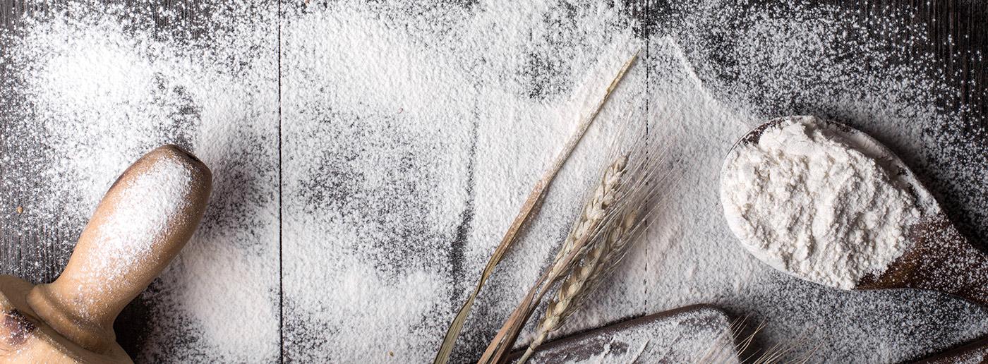 Baking tools on a cutting board, dusted with flour
